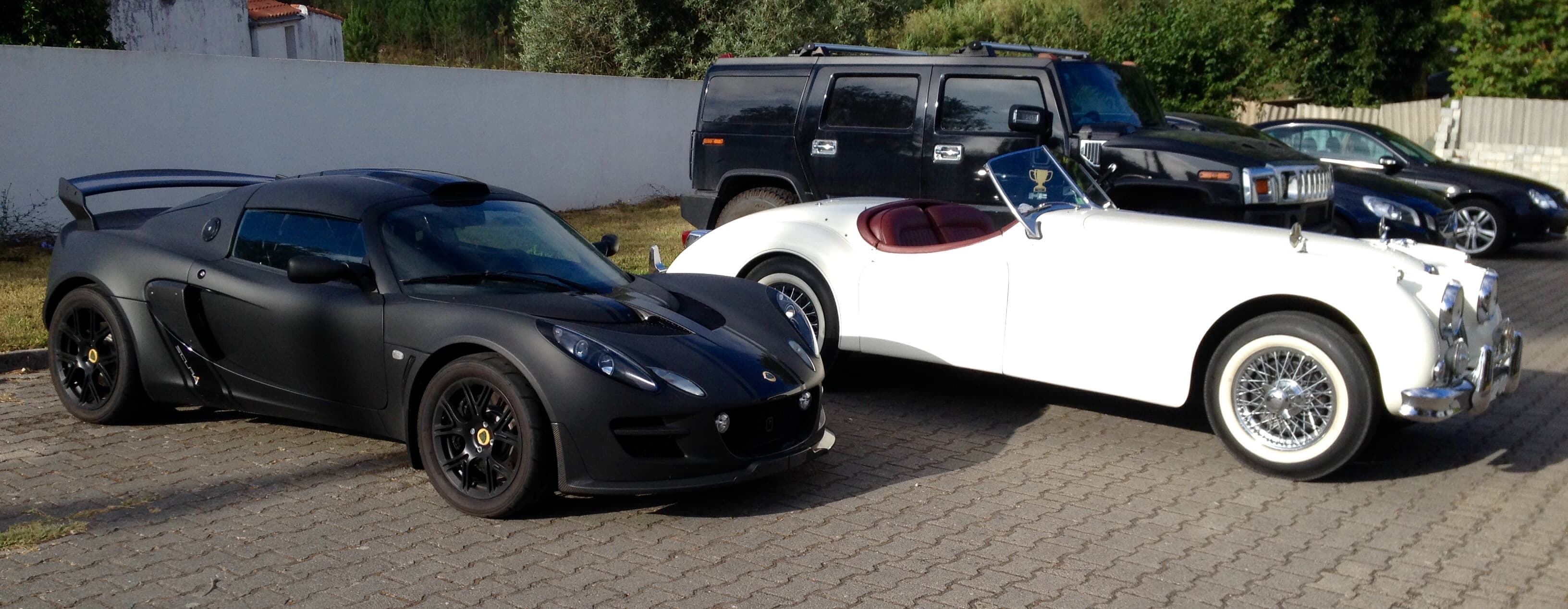 Collection of vehicles including Lotus, classic cars, and luxury vehicles