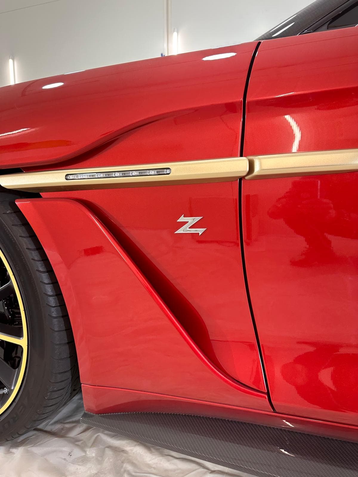 Red car showing glossy paint finish after detailing