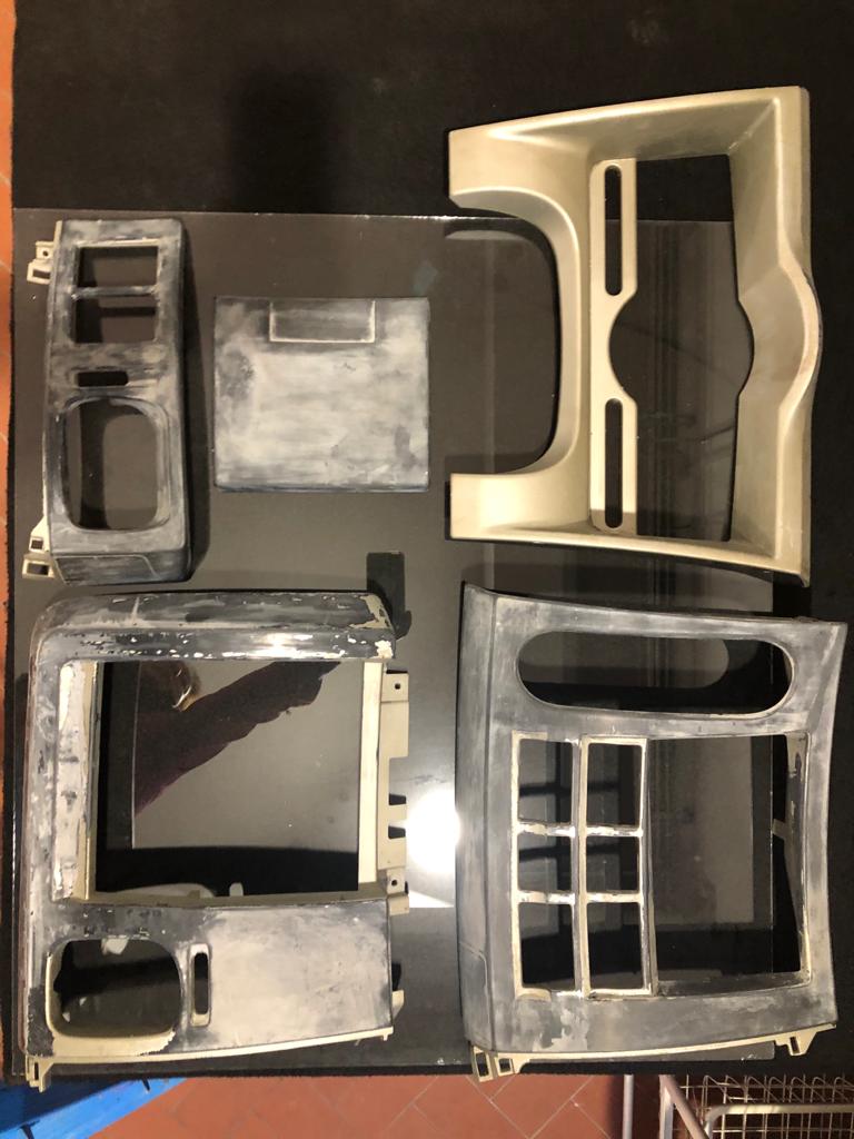 Before and after interior plastic components showing restoration process
