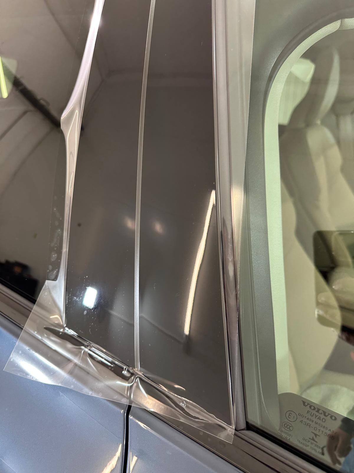 Paint Protection Film application on black piano trim exterior B-pillar work in progress