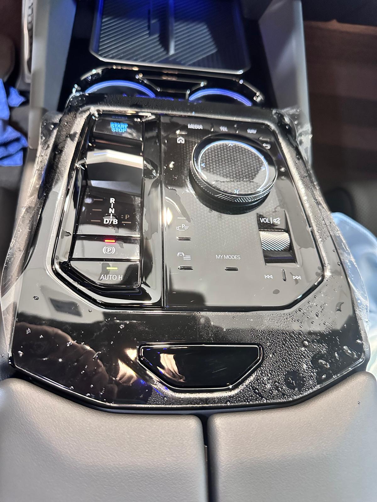 Paint Protection Film installation on interior black piano trim center console work in progress