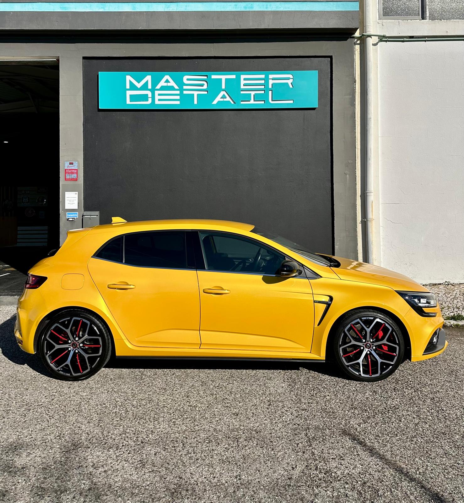 Yellow Renault Megane RS with full Paint Protection Film outside Master Detail shop in Leiria